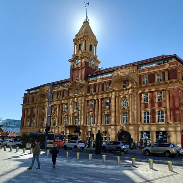 The red-brick and sandstone Ferry Building on Quay Street, its clock tower against a clear blue sky, where the Devonport ferry leaves